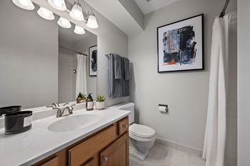 New designer baths with maple cabinetry, marble vanity tops, and brushed nickel fixtures